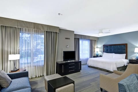 Unwind in a spacious suite with plush bed and lounge.