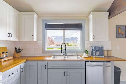 Cooking and doing dishes isn't terrible when you can enjoy farm, mountain, and sunset views