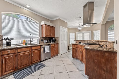Fully equipped kitchen with modern appliances and Keurig coffee station.