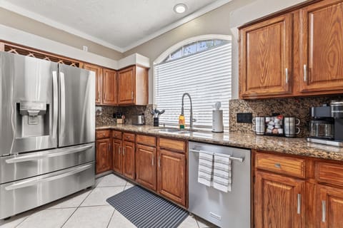 Fully equipped kitchen with modern appliances and Keurig coffee station.