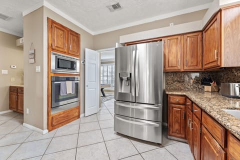 Fully equipped kitchen with modern appliances and Keurig coffee station.