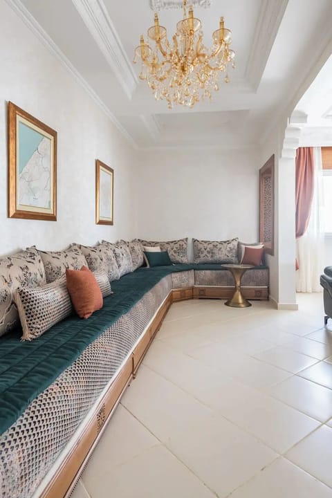 Spacious, traditional Moroccan salon area with tables for eating or taking tea.