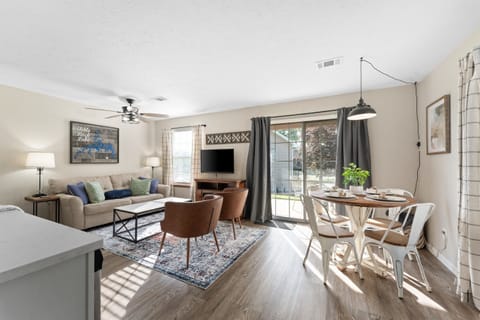 Light and bright living space with golf course views and walk out patio and sleeper sofa