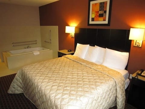 Unwind in plush bedding beside your private soaking tub.