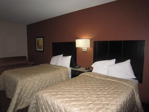 Drift off easily in crisp linens under soft bedside lighting.