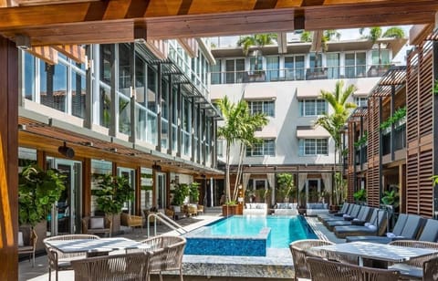 Dive into a chic courtyard pool surrounded by palms.