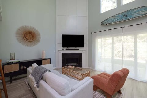 Relax in the coastal-inspired living area featuring airy décor and plenty of natural light.