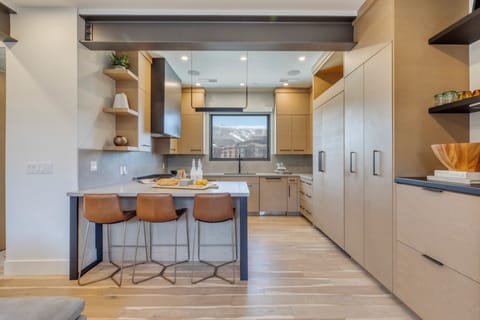 Spacious modern kitchen with barstool seating perfect for breakfast.