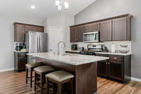 Your spacious kitchen features granite countertops, stainless steel appliances, and a breakfast bar where you can enjoy morning coffee or casual meals together.