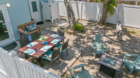 Outdoor Dining Oasis: Enjoy meals under the sun at this vibrant patio with a fire pit!