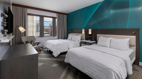 Unwind in crisp twin beds beneath a bold feature wall