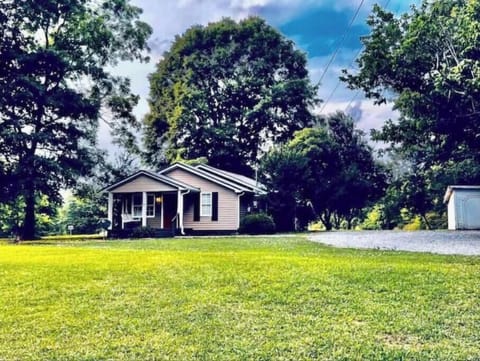 Spacious yard and a porch swing at our farm house.