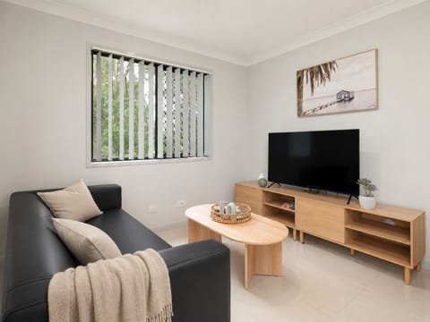Living Area: Bright living space with comfortable seating and TV 