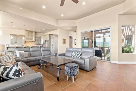 Relax in this spacious living room, complete with 3 plush leather couches that offer plenty of seating. The flat-screen TV is ideal for entertainment, while the large windows add a light and airy ambiance for cozy evenings in.