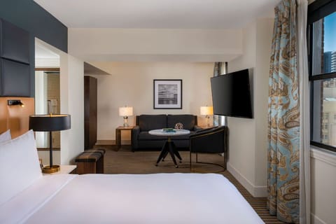 Serene bedroom meets productivity with a dedicated workspace, enveloped in cozy elegance.