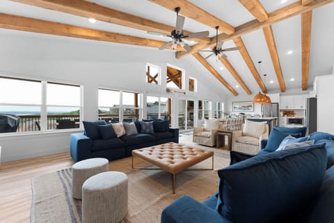 A grand open concept living space with rustic wood beams!