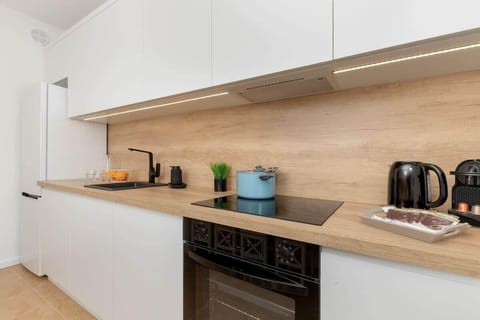 Kitchenette with oven and refrigerator.