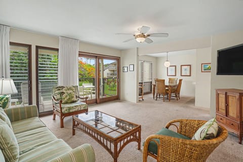 Settle into your tropical-inspired living space, where island breezes drift through open lanai doors and comfortable seating invites you to unwind after exploring the island.