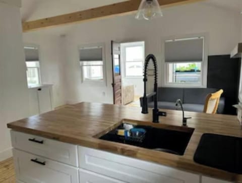 View from kitchen sink out front door to sun porch