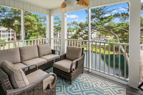 Porch seating with water views at Ocean Keyes 1301, a 4-bedroom vacation rental from Thomas Beach Vacations