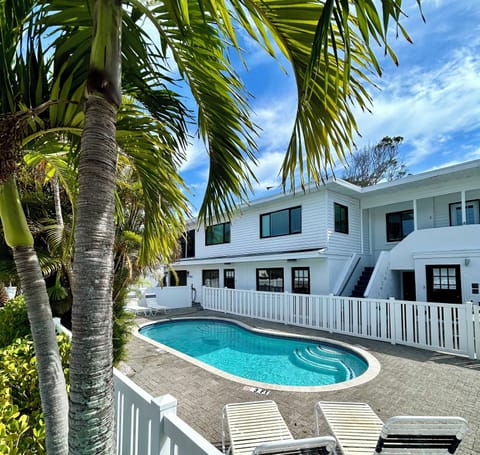 newly painted front exterior of triplex, shared heated pool