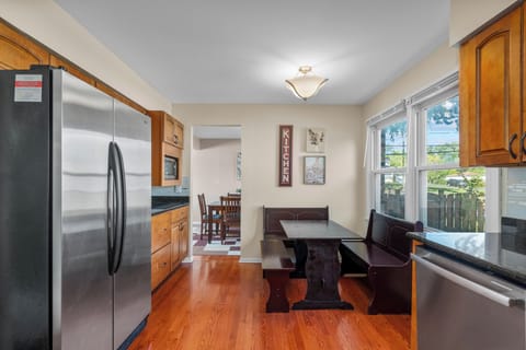 Fully equipped kitchen with breakfast nook by the windows.