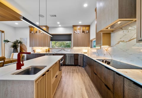 Chic culinary space with sleek fixtures and marble splashes—perfect for creating and tasting