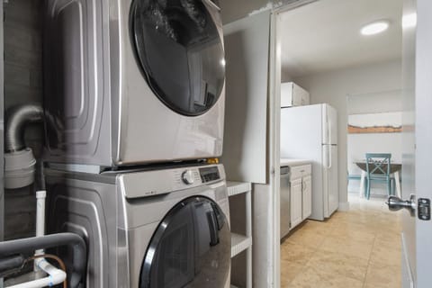 Indoor Laundry & utility half bath with Samsung washer/dryer and essentials.