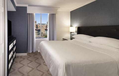 Wake up to sunlit comfort and a captivating city view.
