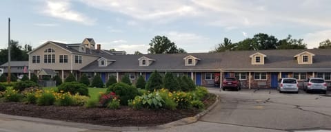 Arrive to a welcoming, garden-lined property at golden hour.