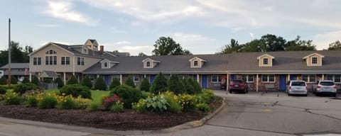 Arrive to a welcoming, garden-lined property at golden hour.