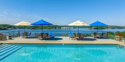 HOA pool area with tables, chairs, lake view