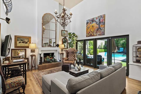 The living room has ultra-high ceilings and plush furnishing.