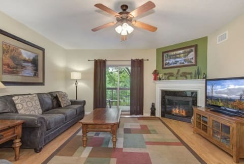 2 Bedroom Pigeon Forge Vacation Condo Rental Cedar Lodge 204 - Spacious Living Room with Gas Fireplace, Sleeper Sofa and SMART TV with Cable & WIFI throughout vacation rental