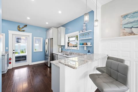 The kitchen is open to the dining room with a breakfast bar.