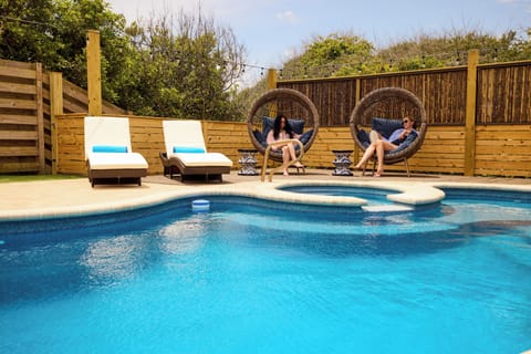 Pool with spa chaise lounges , egg chairs and outdoor sectional