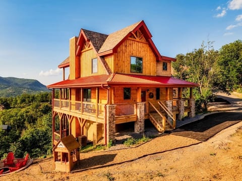 Front view of the cabin, mini-cabin just for the kids, and the gravel path which leads to our amazing fire pit.  All of these amenities have spectacular views.  Bear Mountain Vista cabin.