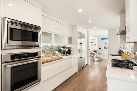 The sleek kitchen boasts top-of-the-line appliances and ample counter space.