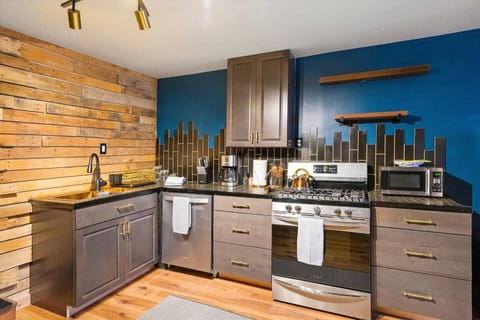 Full kitchen space with refrigerator, microwave, gas stove, coffee maker and dishwasher