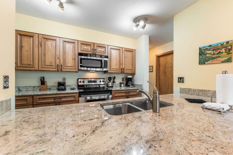 Full size kitchen featuring stainless steel appliances and granite countertops.