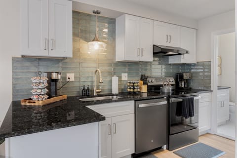 Modern kitchen with a vibrant turquoise backsplash, designed for culinary enthusiasts who appreciate style and efficiency.