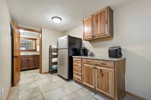 Kitchenette with a large refrigerator, an ice maker, a Keurig, and slow cooker.