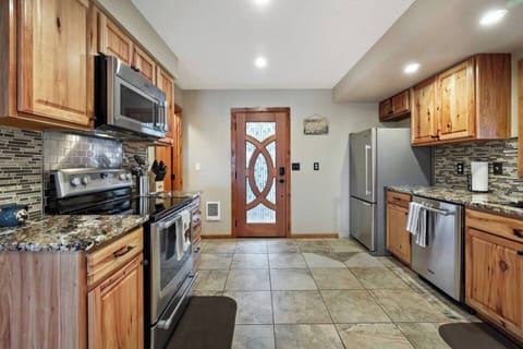 It features a refrigerator, microwave, electric range, oven, and dishwasher.