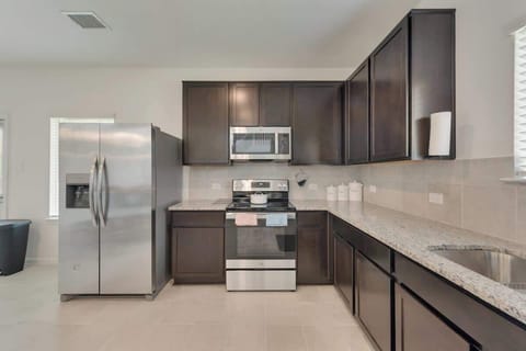 Full Kitchen with Dinning Cooking basics Dishwasher Hot water kettle Microwave Oven Refrigerator Stove Baking sheet Blender Coffee maker Dishes and silverware Freezer Rice maker Toaster Wine glasses Trash compactor