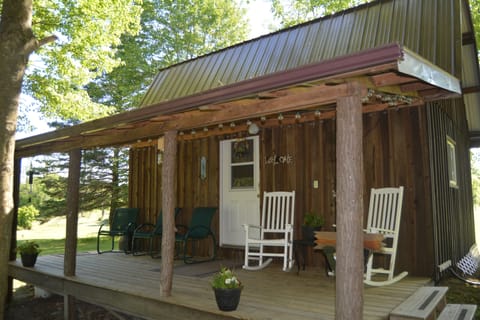 Front porch facing the woods. 
Seating  for 5 with soft lighting.