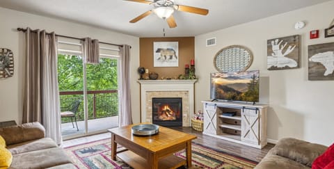 Two Bedroom Condo Pigeon Forge Sleeps 6 on the River Cedar Lodge - Spacious Living Room with Gas Fireplace, Sleeper Sofa and SMART TV with Cable & WIFI throughout vacation rental