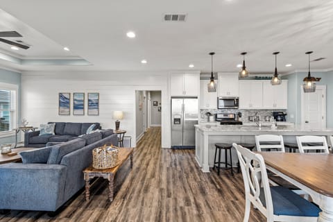 Open living, dining and kitchen areas.