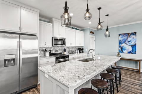 Large kitchen to accommodate multiple cooks. Pantry in corner.