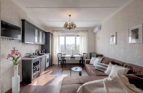 Bright and spacious living room with modern decor, offering the perfect spot to relax after a day exploring the city