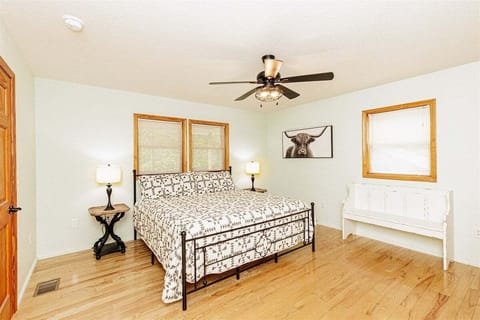 Comfortable downstairs king bedroom featuring hardwood floors and rustic decor in a Great Smoky Mountains family rental.
